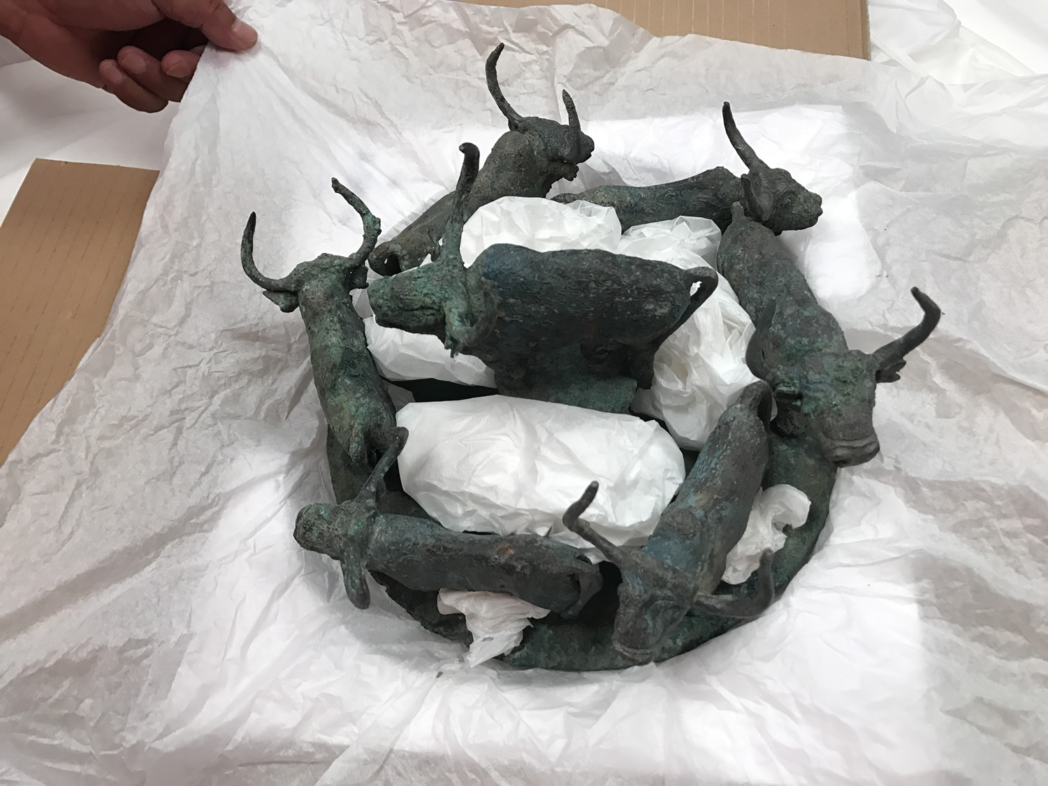 Bronze animal figures packed in tissue