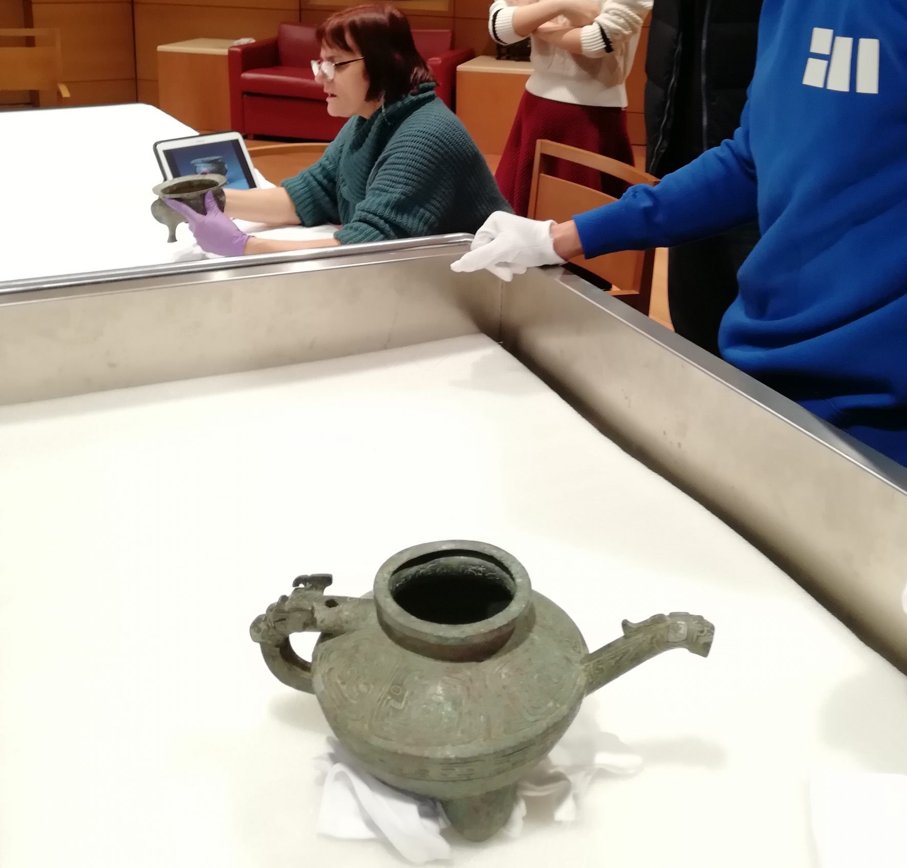 A bronze vessel reviewed during unpacking