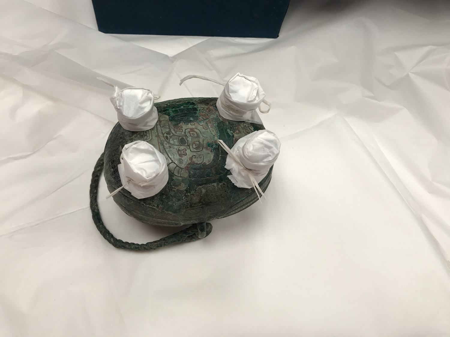 A bronze vessel with padded feet