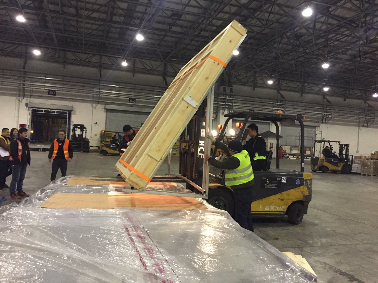 A forklift lifting a wooden crate