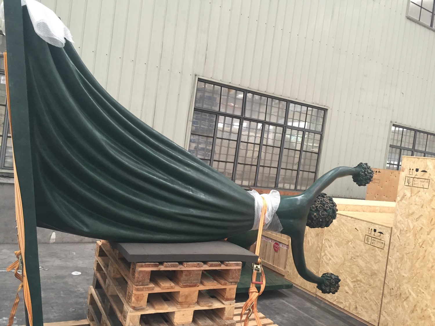 A sculpture secured in a warehouse
